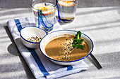 From above healthy food set with mushroom soup and apple water
