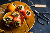 Persimmons on autumnal table setting, seasonal decor theme