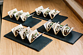 Gourmet tacos on elegant black slate trays