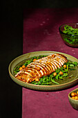 Sliced roasted turkey breast with arugula and chickpeas