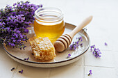 Jar with honey and fresh lavender flowers