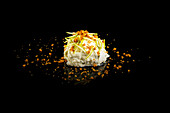 Elegant Asian cuisine: ice cream with crispy topping on a black background