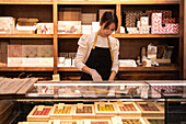 Saleswoman arranges chocolates