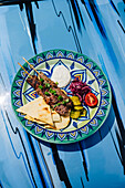 Mediterranean skewered meat beef kebab with tzatziki and pita