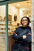 Proud vegan pastry chef in front of her bakery