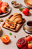 Persimmon-themed gourmet breakfast with pastries and fruit