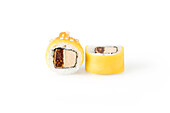 Two pieces of sushi with mango on white background