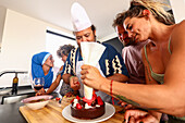 A group of friends enjoying a fun cake decorating activity