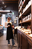 Woman managing inventory in a chocolate shop