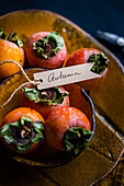 Autumnal table setting with persimmons and themed pendant