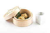 Bamboo steamer with Chinese dumplings and soya sauce