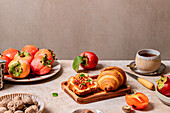 Breakfast table with plum-themed pastries and tea