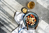 Top view of gourmet salad and wine on textured background