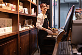 Smiling saleswoman in a chocolate shop