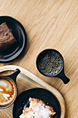 Assorted breakfast items on a wooden table in a setting