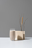 Minimalist display of tiger nut horchata with an artistic backdrop