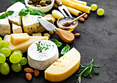 Various cheeses, grapes, honey and snacks