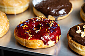 Assortment of gourmet vegan donuts with various toppings