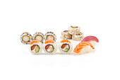 Variety of fresh sushi rolls and nigiri on white background