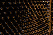 Aged wine bottles in a traditional Kakhetian cellar