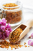 Healthy bee pollen grains. Bee pollen on a glass jar and acacia