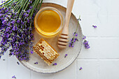 Jar of honey and fresh lavender flowers