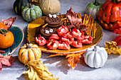 Festive Halloween treats display with cookies and fruits