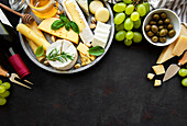 Assorted cheeses, grapes, wine and snacks