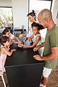 Family interaction in the kitchen while baking biscuits