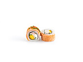 Fresh sushi pieces with a delicate arrangement on white