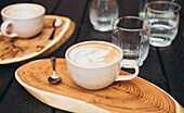 Artistic top view of morning coffee on wooden tray