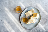 Traditional Georgian sulguni cheese and amber-coloured wine on a plate