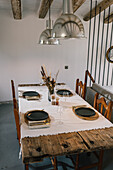 Elegantly set dinner table in a modern rustic dining room