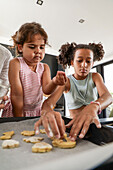 Family baking biscuits together