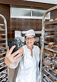 Satisfied baker takes a selfie at work