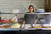 Woman serving traditional food in El Salvador