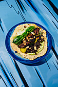 Tortilla with veal cheeks on a blue plate