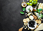 Various cheeses, grapes, honey and snacks