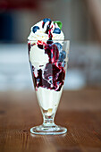 Ice cream sundae with blueberries and whipped cream