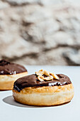 Chocolate-Covered Donuts with Peanut and Chocolate Sprinkle Toppings