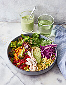 Millet bowl with oven vegetables and avocado sauce
