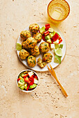 Spicy oat balls with avocado-feta salad
