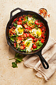 Oriental oat shakshuka with spinach and olives