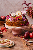 Autumn fruit cake decorated with flowers, figs and grapes