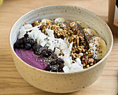 Acai bowl with granola, bananas and berries