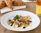 Detox banana split with yoghurt, superfoods and berry mix