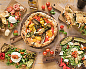 Italian pizza and calzone with antipasti and salad