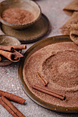 Ceylon cinnamon sticks lying in cinnamon sugar