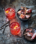 Negroni, bacon dates with goat's cheese