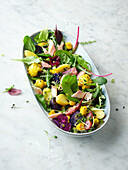 Wild herb and potato salad with cauliflower and trout